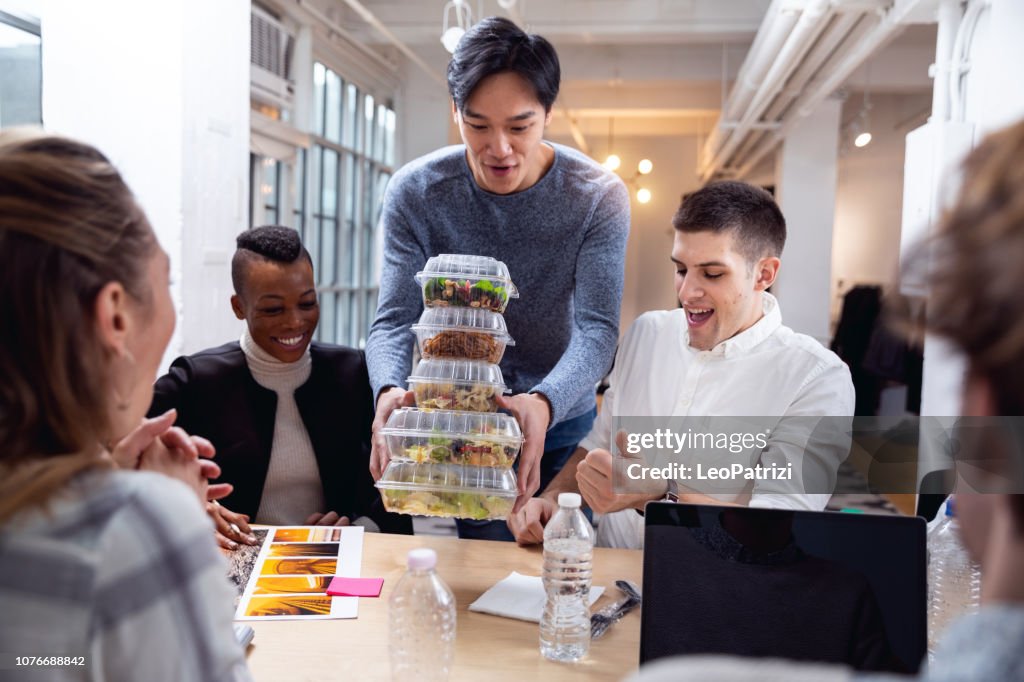 Young team eating in the office at lunch break