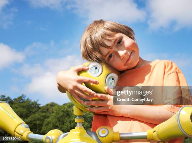 young boy with robot companion - llandysul stock pictures, royalty-free photos & images