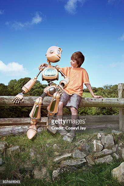 young boy with robot companion - human attribute fotografías e imágenes de stock