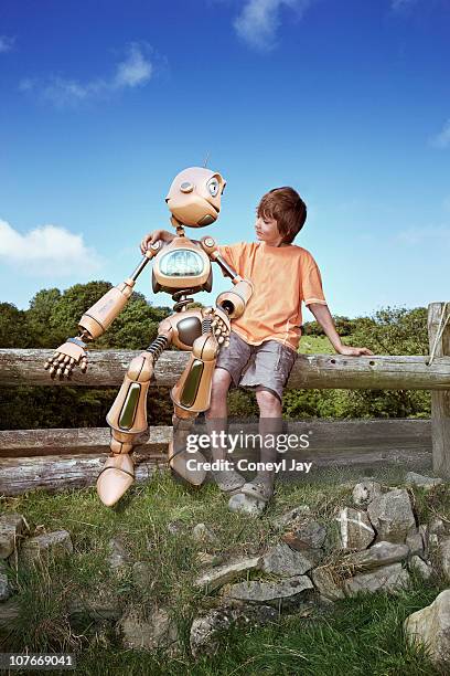 young boy with robot companion - anthropomorphic stock pictures, royalty-free photos & images