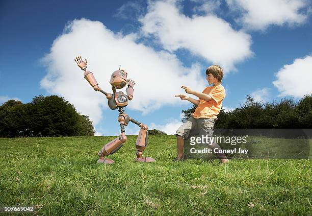 young boy with robot companion - llandysul stock pictures, royalty-free photos & images