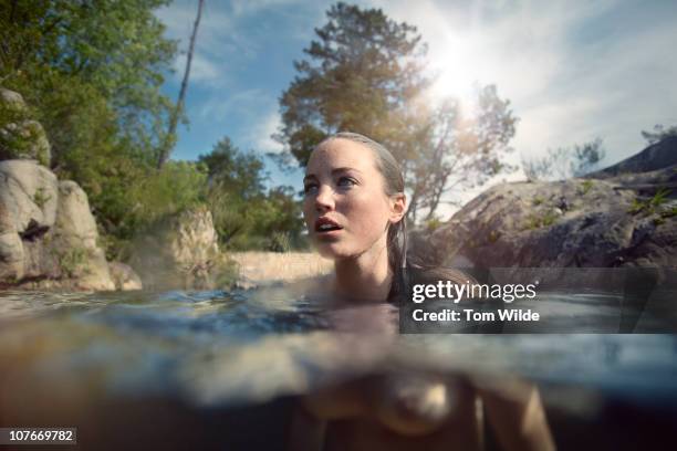 young woman naked in water - nudity foto e immagini stock