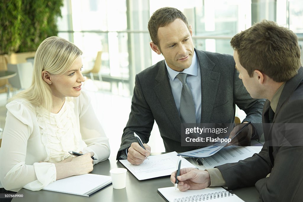 Three business people having a meeting