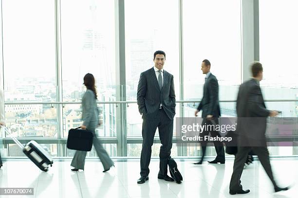 businessman standing out from the crowd - newbusiness stock pictures, royalty-free photos & images
