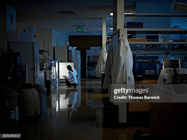 scientist looking in refrigerator in research lab - working overtime imagens e fotografias de stock