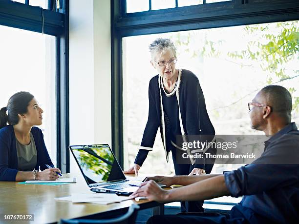 coworkers in discussion at conference table - listening skills stock pictures, royalty-free photos & images