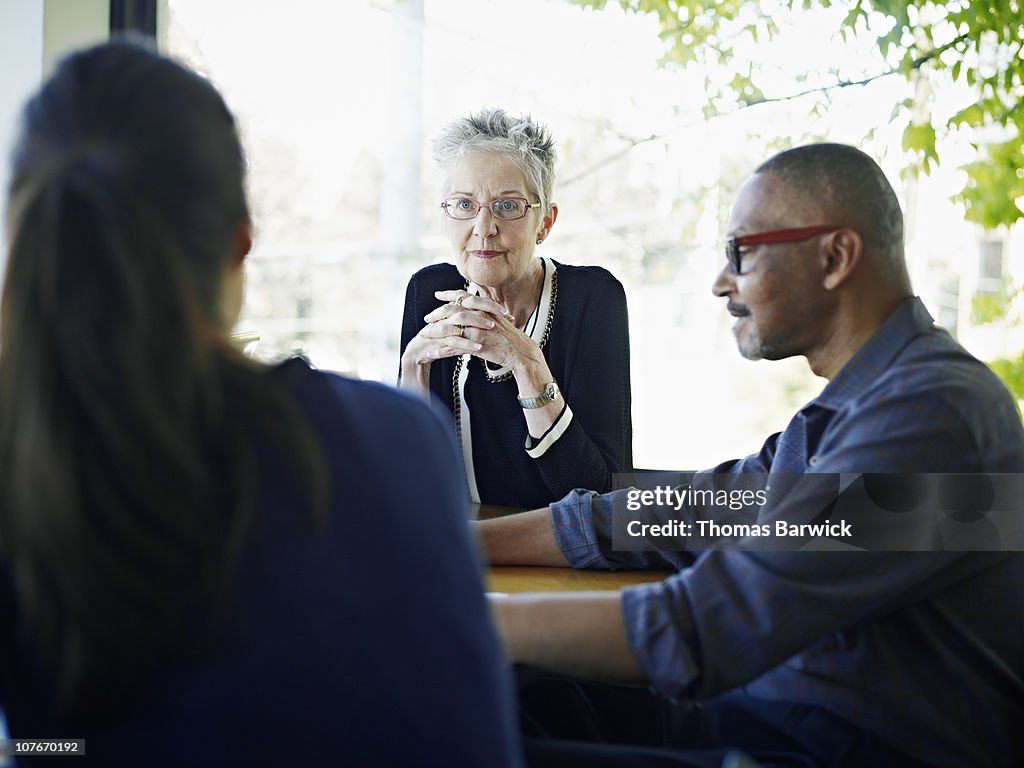 Coworkers in discussion at conference table