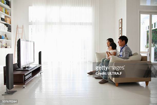 young family watching tv - リビング　家族　日本 ストックフォトと画像
