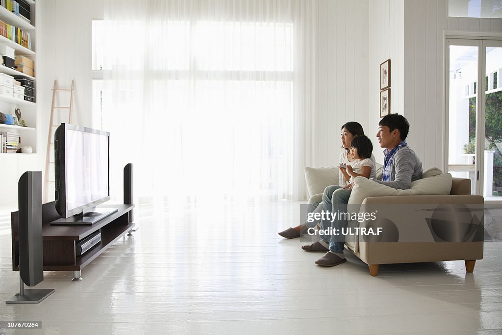 Young family watching TV