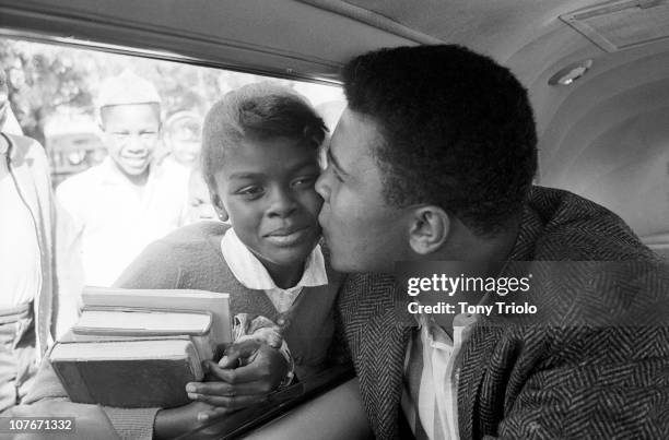 Cassius Clay kissing young female fan from car window.Miami, FL 2/28/1964CREDIT: Lee Balterman