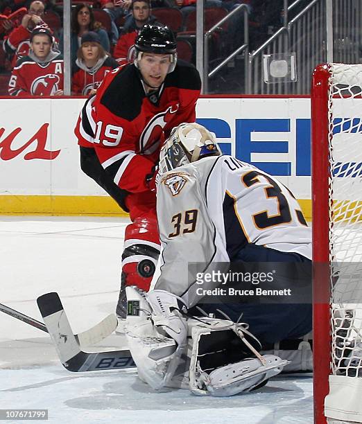 Travis Zajac of the New Jersey Devils takes the shot against Anders Lindback of the Nashville Predators at the Prudential Center on December 17, 2010...