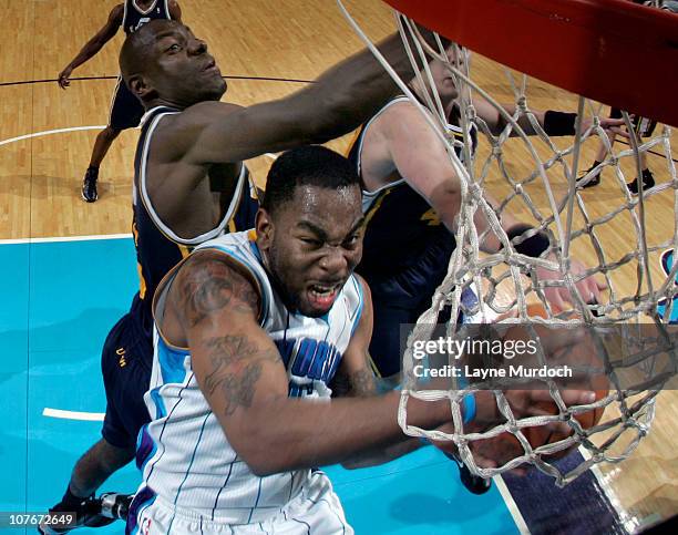 Marcus Thornton of the New Orleans Hornets attempts a layup while being guarded by Francisco Elson of the Utah Jazz on December 17, 2010 at the New...