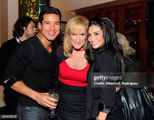 Host Mario Lopez, Extra Sr. Executive Producer Lisa Gregorisch-Dempsey and actress Courtney Laine Mazza attend the "Extra" holiday party at La Piazza...