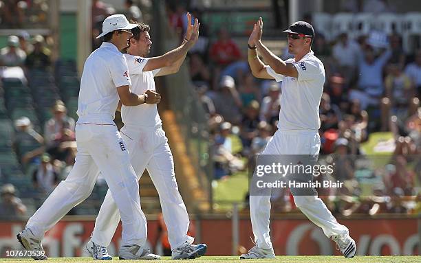 James Anderson of England celebrates with team mates after taking the wicket of Peter Siddle of Australia, his 200th career Test wicket during day...