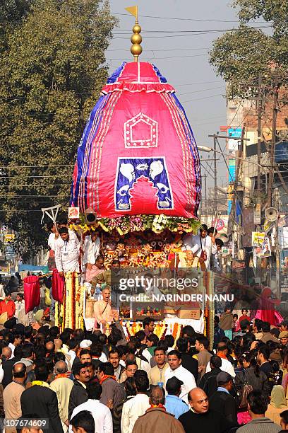 Indian Hindu devotees pull a chariot of Lord Jagannath, his brother Balabhadra and sister Subhadra as thousands of devotees gather at the annual...