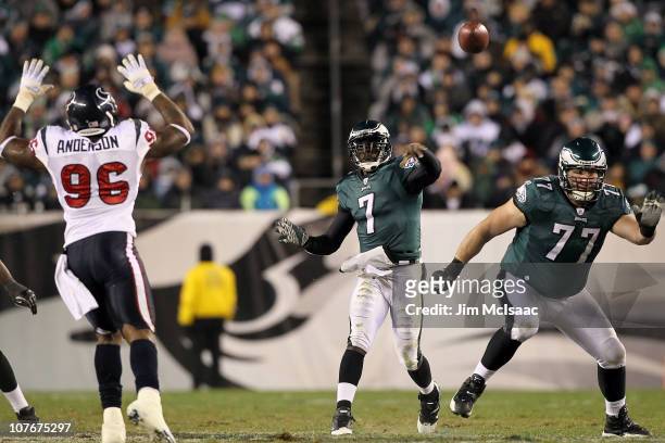 Quarterback Michael Vick of the Philadelphia Eagles passes the ball behind the blocking of Mike McGlynn against the Houston Texans at Lincoln...