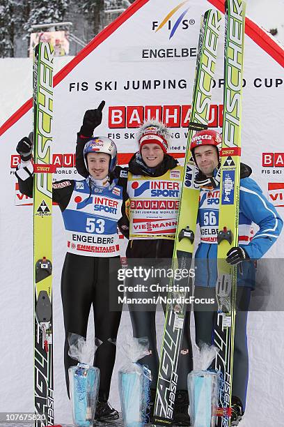 Adam Malysz of Poland celebrates with Thomas Morgenstern of Austria and Matti Hautamaeki of Finland after the individual HS137 during the FIS Ski...