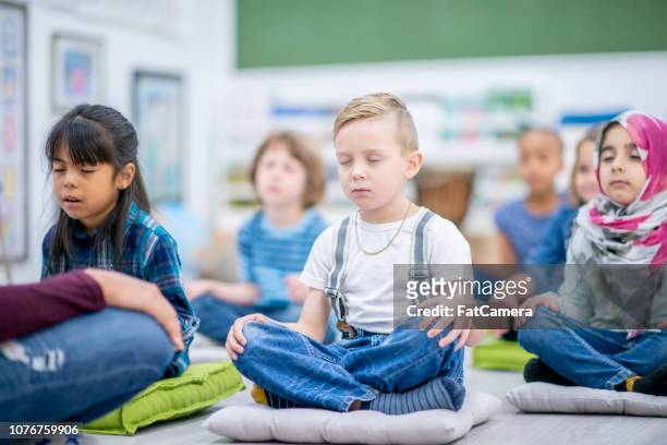 meditation class - kids meditating stock pictures, royalty-free photos & images