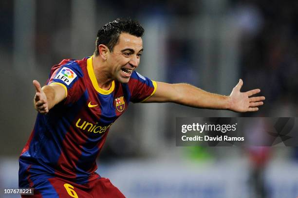 Xavi Hernandez of Barcelona celebrates after scoring his team's second goal during the La Liga match between Espanyol and Barcelona at Cornella - El...