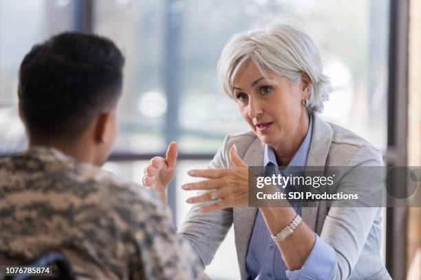 caring therapist counsels injured young soldier - injured us army stock pictures, royalty-free photos & images