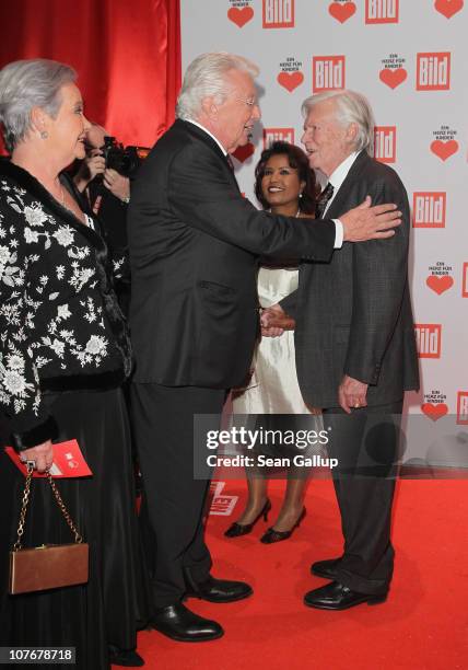 Dieter Thomas Heck , flanked by his wife Ragnhild Heck , greets Karlheinz Boehm at the 'Ein Herz Fuer Kinder' charity gala at Axel Springer Haus on...