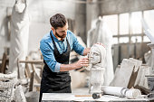 Sculptor working with sculpture in the studio