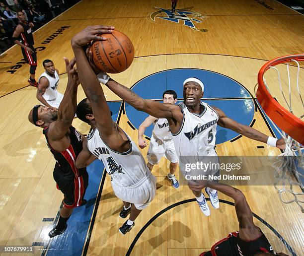 Josh Howard of the Washington Wizards rebounds against Erick Dampier of the Miami Heat at the Verizon Center on December 18, 2010 in Washington, DC....