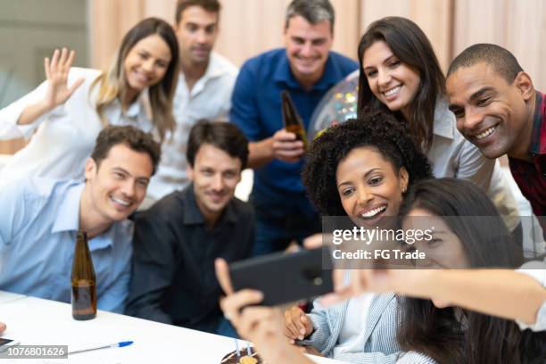 business colleagues taking a selfie at birthday party at work - work anniversary stock pictures, royalty-free photos & images