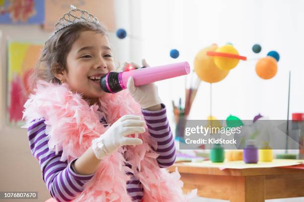 latin girl singing using a microphone - kidstock girl stock pictures, royalty-free photos & images