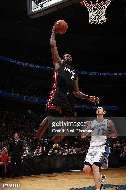 LeBron James of the Miami Heat dunks against Kirk Hinrich of the Washington Wizards at the Verizon Center on December 18, 2010 in Washington, DC....