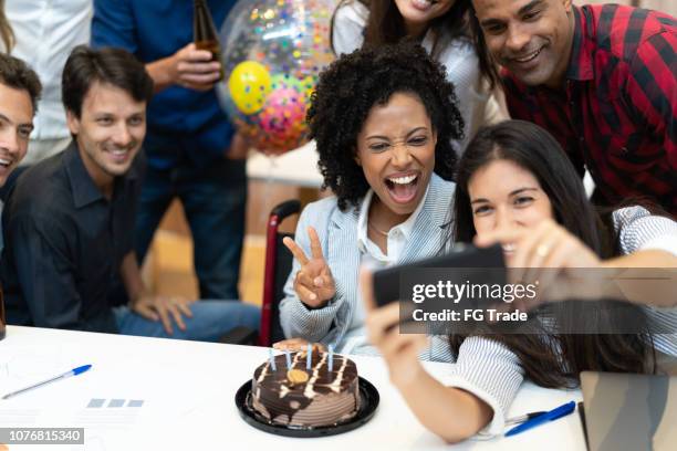 business colleagues taking a selfie at birthday party at work - party office stock pictures, royalty-free photos & images