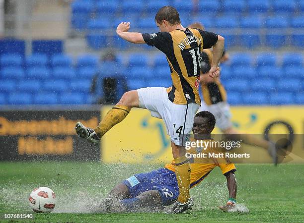 Adama Traore of Gold Coast contests the ball with Michael McGlinchey of the Mariners during the round 19 A-League match between Gold Coast United and...