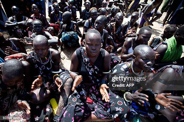 Mundari singers cheer for their tribe during the the final of Sudan's first commercial wrestling league between the Mundari tribe from Central...