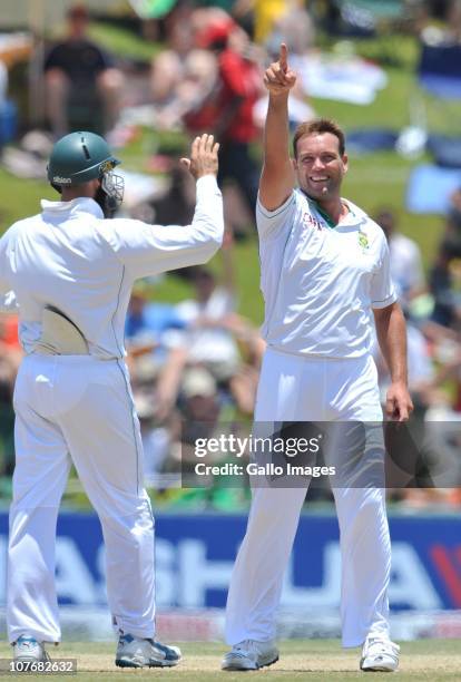 Jacques Kallis of South Africa celebrates with Hashim Amla after capturing the wicket of Suresh Raina during day 4 of the 1st Test match between...