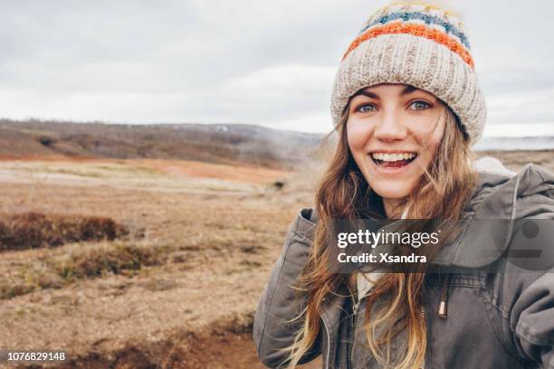 young woman taking selfie portrait in iceland - knit hat stock pictures, royalty-free photos & images