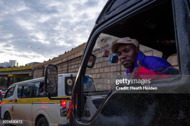 Man gestures from a van as stranded commuters are forced to walk for hours to make their public transport connection on opposite sides of the city...