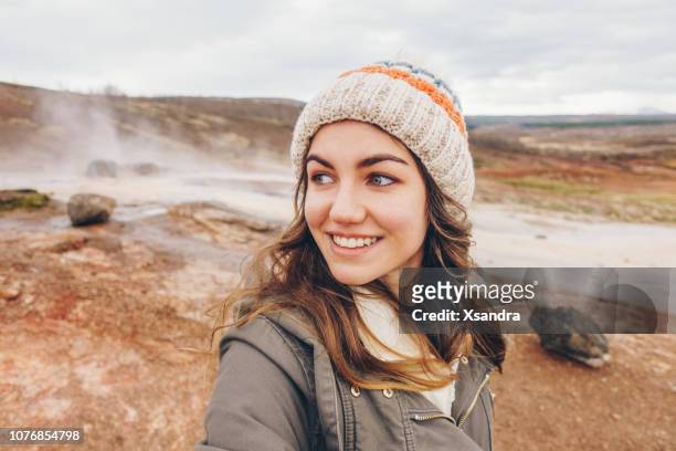 young woman taking selfie portrait in iceland - geyser stock pictures, royalty-free photos & images