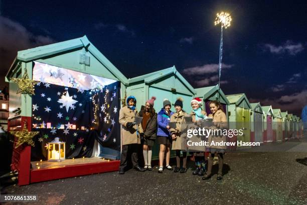 Children from Windlesham School in Brighton singing carols at the 10th annual Beach Hut Advent Calendar on the city's seafront. Each evening, between...