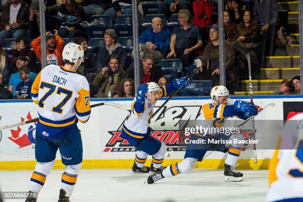 Gary Haden and Dawson Davidson of the Saskatoon Blades celebrate the overtime winning goal against the Kelowna Rockets at Prospera Place on December...