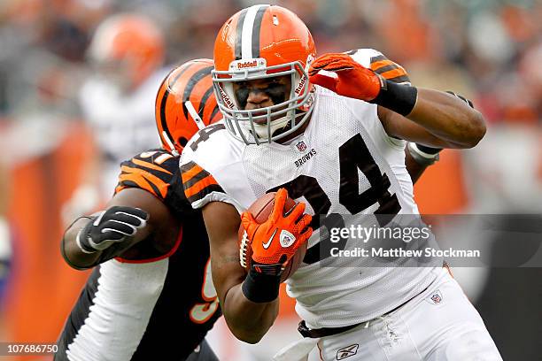 Robert Royal of the Cleveland Browns attempts to break free from Robert Geathers of the Cincinnati Bengals after making a reception at Paul Brown...