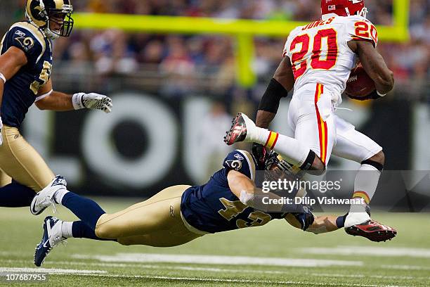 Craig Dahl of the St. Louis Rams looks to tackle Thomas Jones of the Kansas City Chiefs at the Edward Jones Dome on December 19, 2010 in St. Louis,...