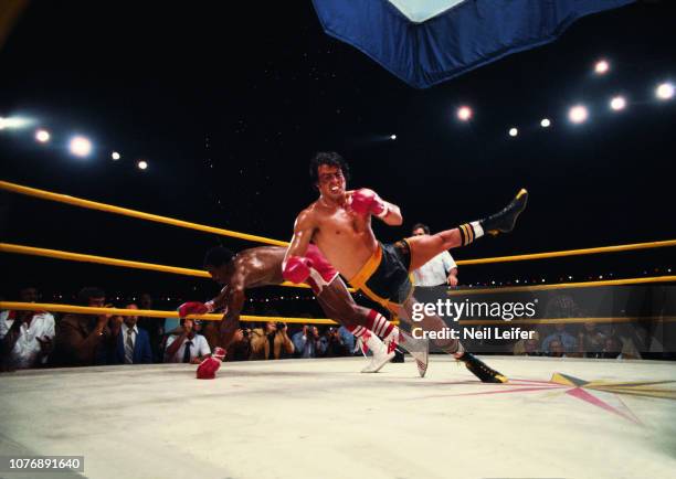 Sylvester Stallone , as Rocky Balboa, in action vs Carl Weathers, as Apollo Creed, during fight sequence in filming on the set of "Rocky II" movie....