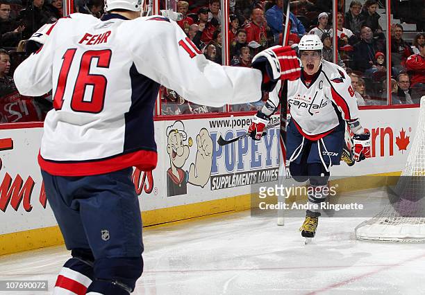 Alex Ovechkin of the Washington Capitals celebrates a goal by teammate Eric Fehr against the Ottawa Senators during second period action at...