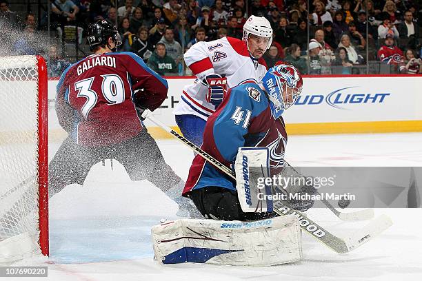 Goaltender Craig Anderson of the Colorado Avalanche makes a save against the Montreal Canadiens as T.J. Galiardi defends against Tomas Plakanec at...