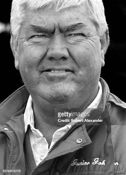 Legendary former NASCAR driver and car owner Junior Johnson stands in the speedway garage prior to the start of the 1986 Daytona 500 stock car race...