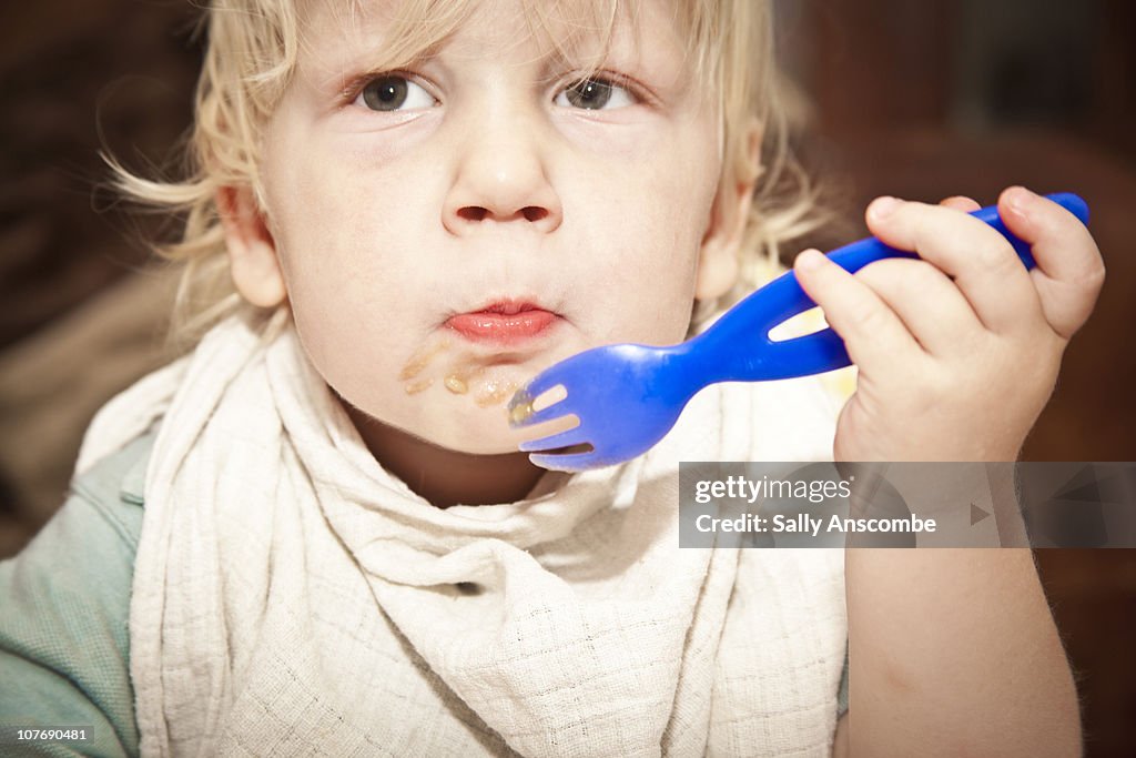 Small child eating dinner