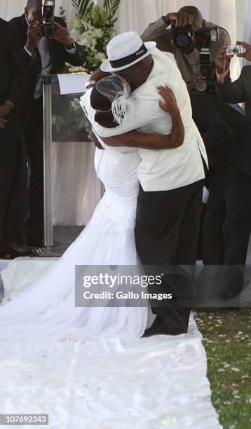 South African National Police Commissioner Bheki Cele kisses his new wife, Thembeka Ngcobo, at their wedding, held at the elite Lynton Hall Estate on...