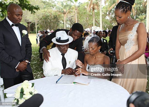 South African National Police Commissioner Bheki Cele and his new wife, Thembeka Ngcobo, sign the wedding register at their wedding, held at the...