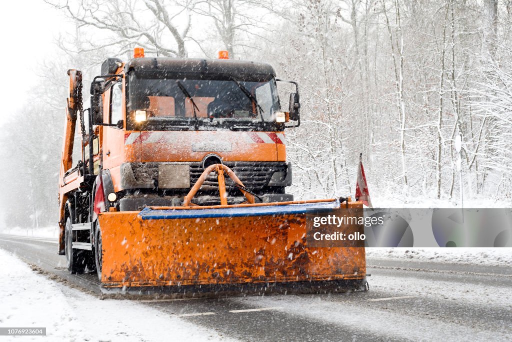 Snow plow truck - winter road conditions, heavy snowfall