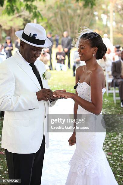 An emotional South African National Police Commissioner Bheki Cele and his new wife, Thembeka Ngcobo, exchange rings at their wedding, held at the...